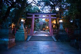Stone lanterns and forested path leading toward Kasuga Taisha in Nara